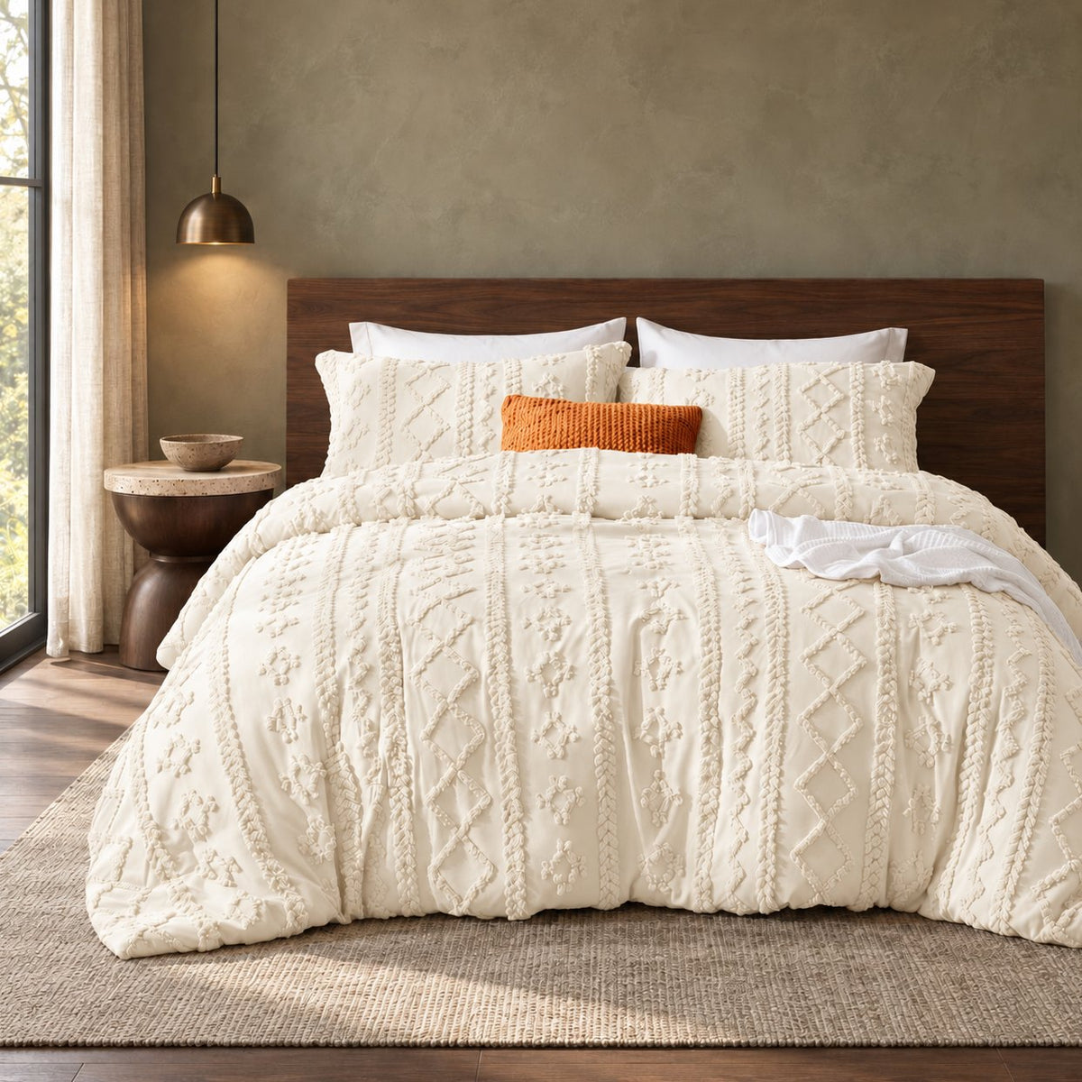 Ivory tufted comforter set on a bed