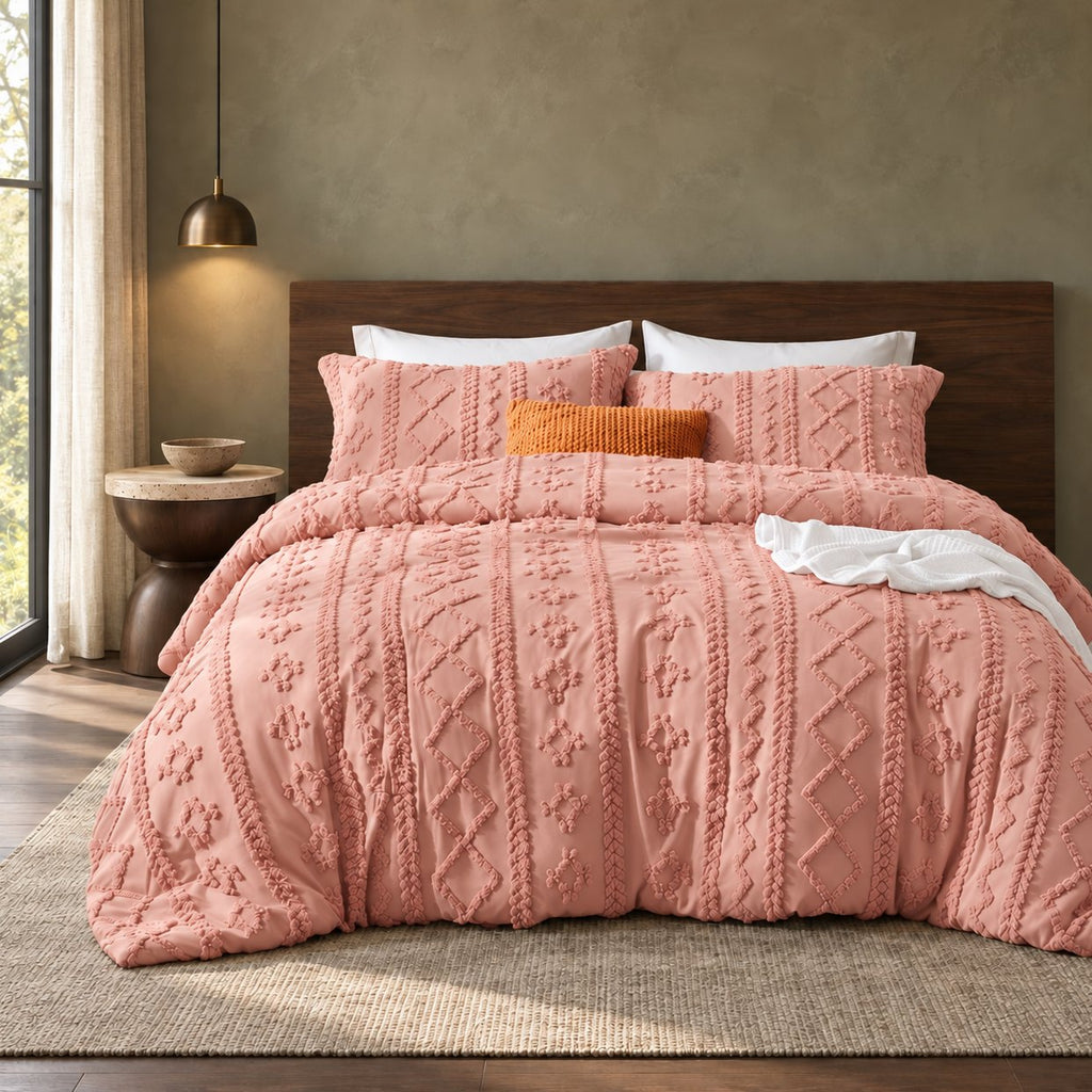 Pink tufted comforter set on a bed