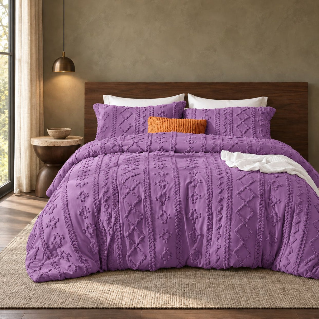 Purple tufted comforter set on a bed