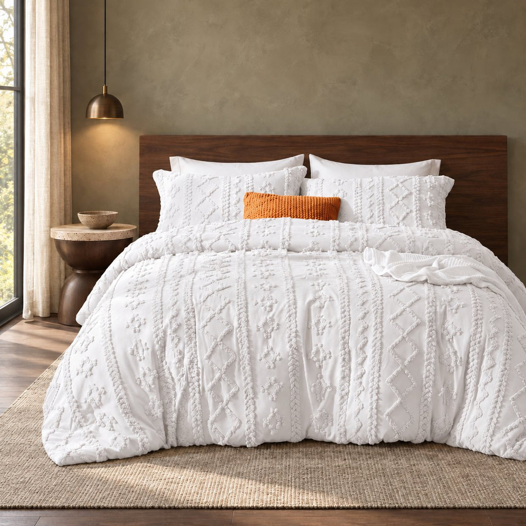 White tufted comforter set on a bed